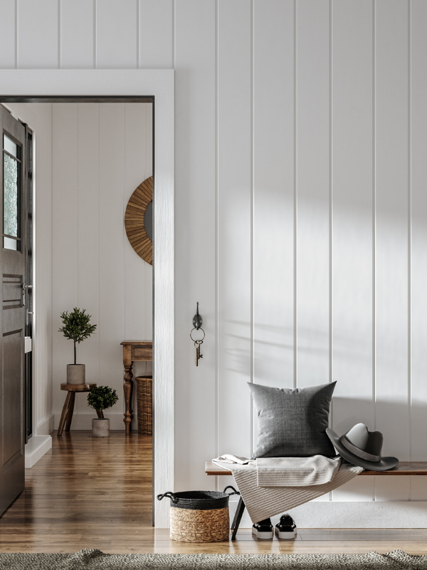 Hallway doorframe with white wood paneling 