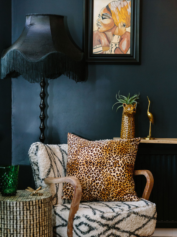 Black wall and radiator with black lamp and patterned chair