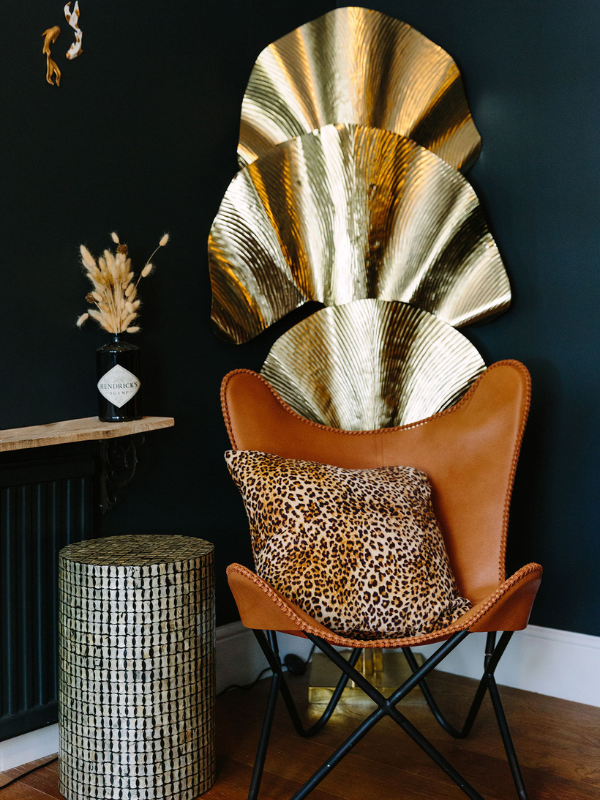 Oversized chair and golden fan feature