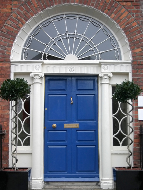 Front door with topiary trees either side 