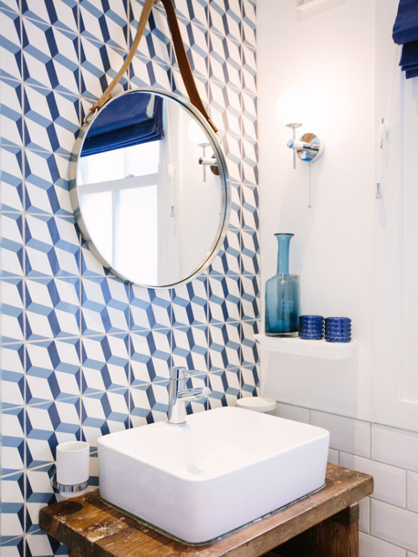 bathrom sink with blue patterned wallpaper 