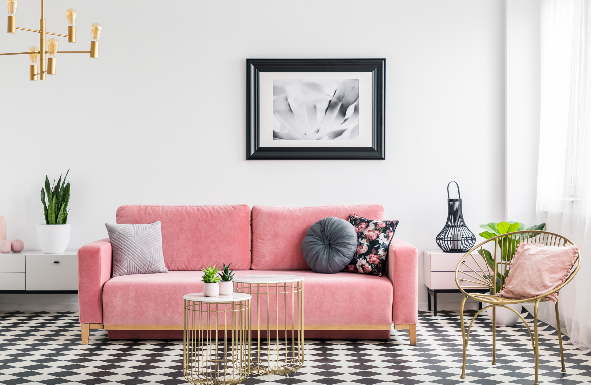 Living room with pink sofa and black and white patterned floor