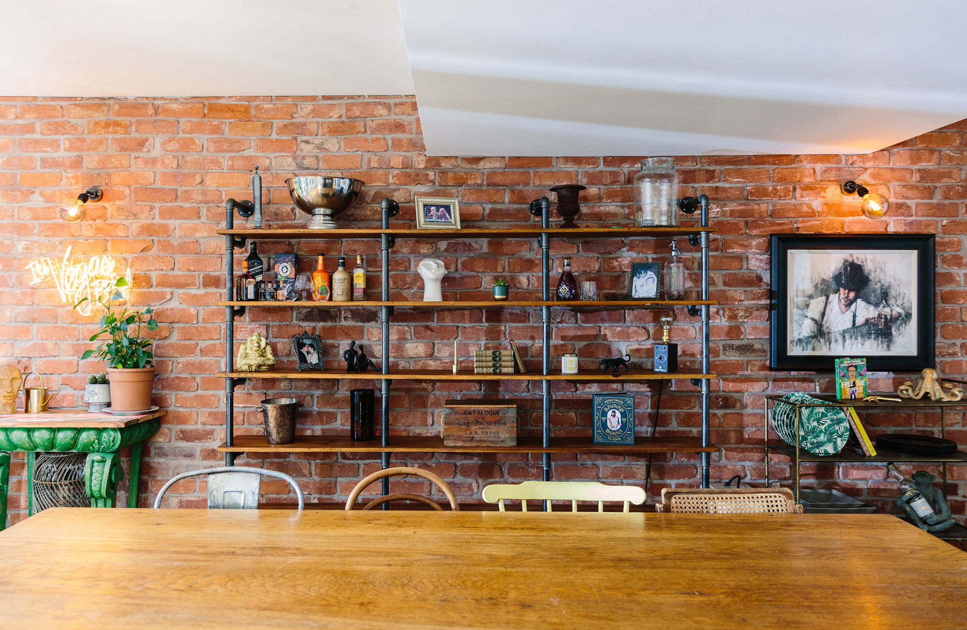 Shelves with various knick knacks infront of an exposed brick wall