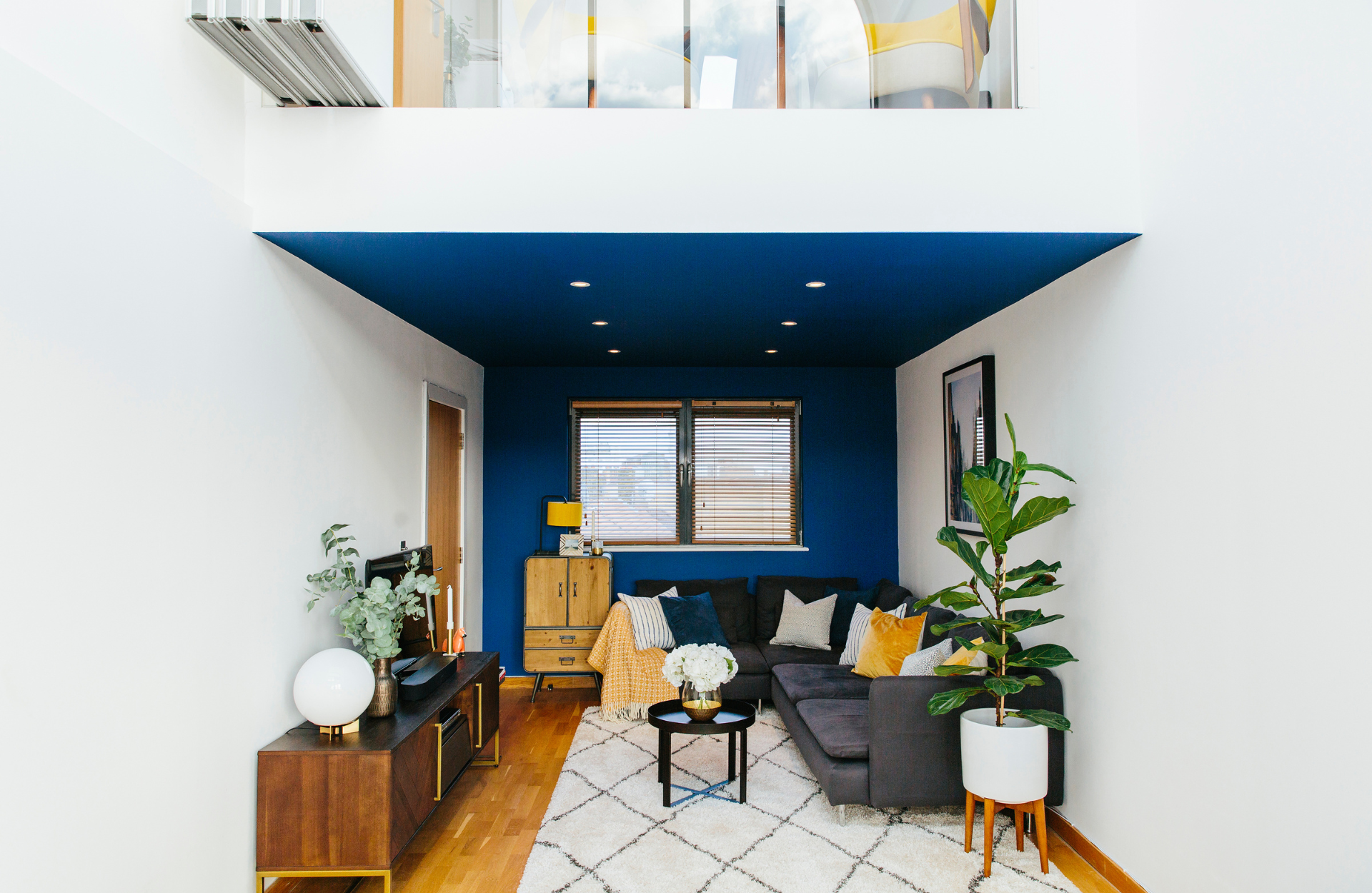 blue and white living room with corner sofa