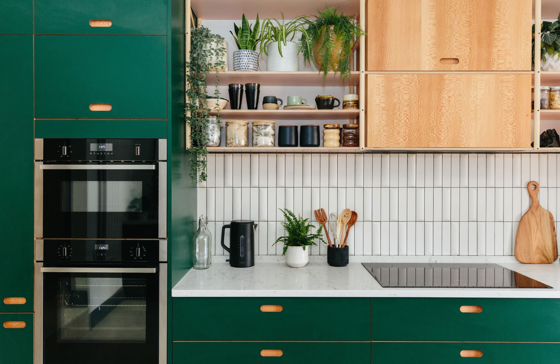 Kitchen with green cabinets and white tile backsplash