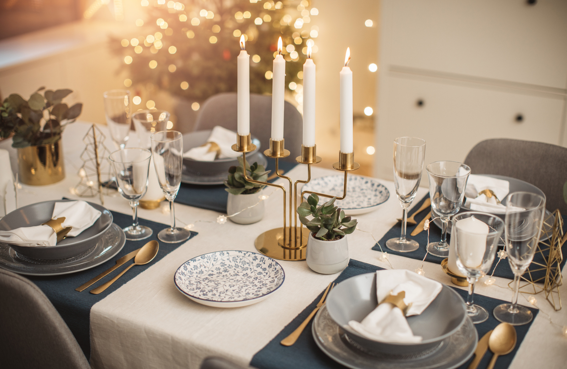 christmas table with layered plates and placemats 