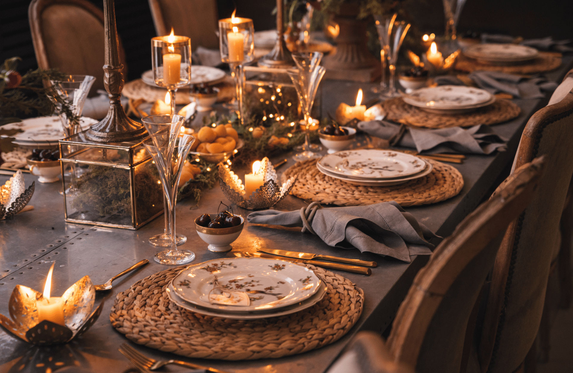 Warm christmas table scape with candles and oranges