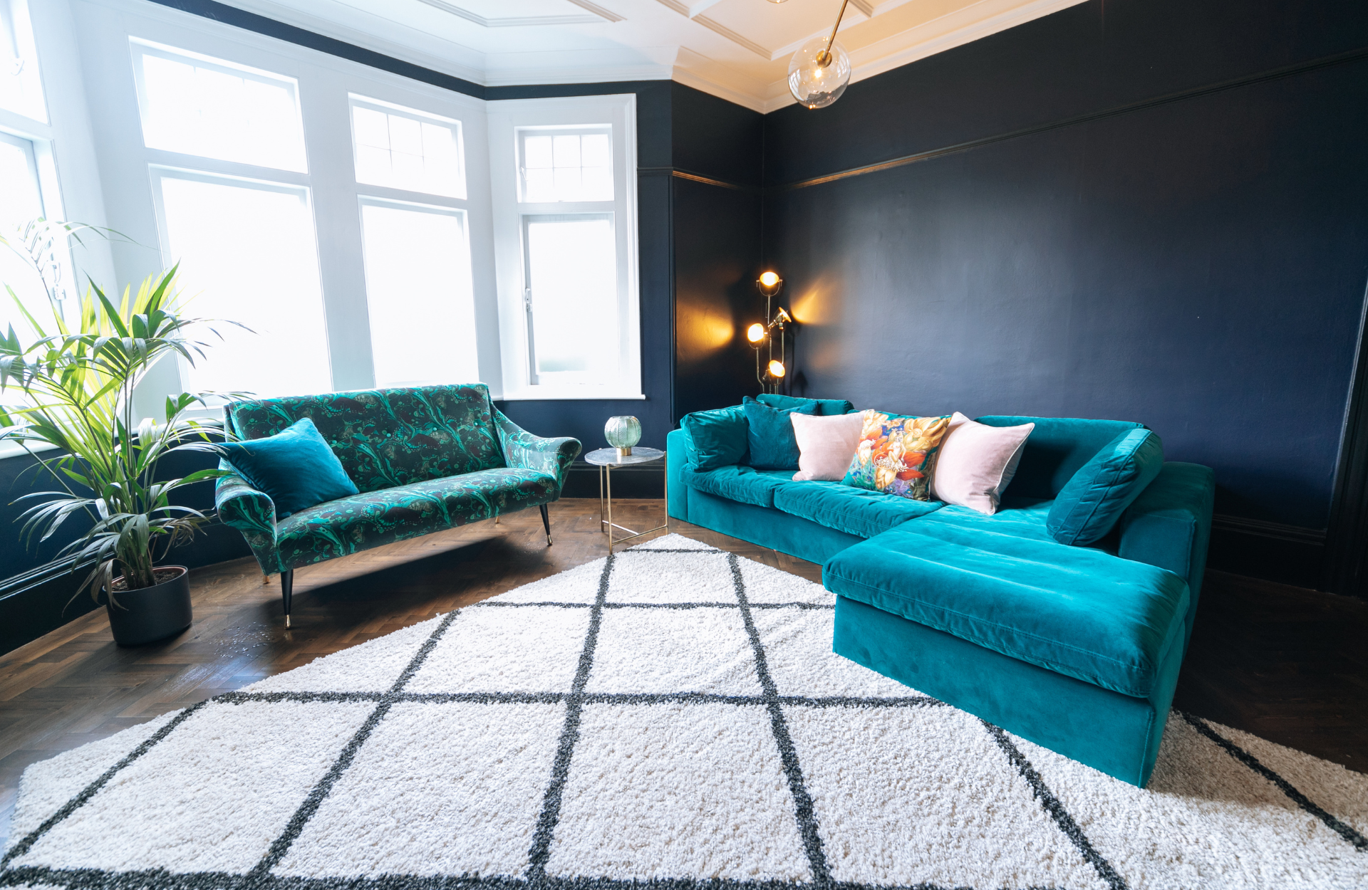 Living room with blue sofas and patterned rug 