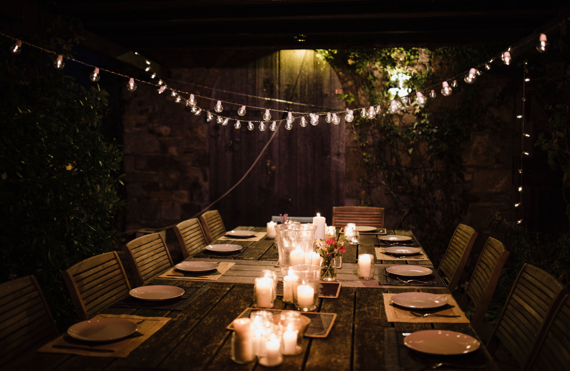Outdoor dining area with string lights and candles