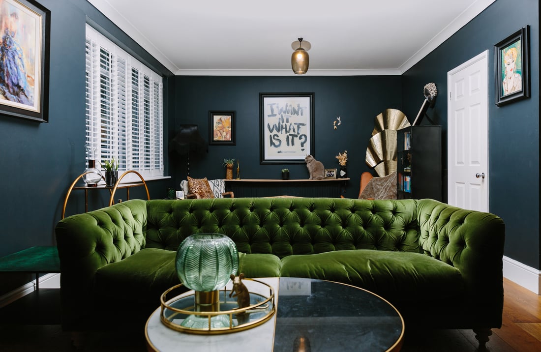 bold dark living room with green sofa