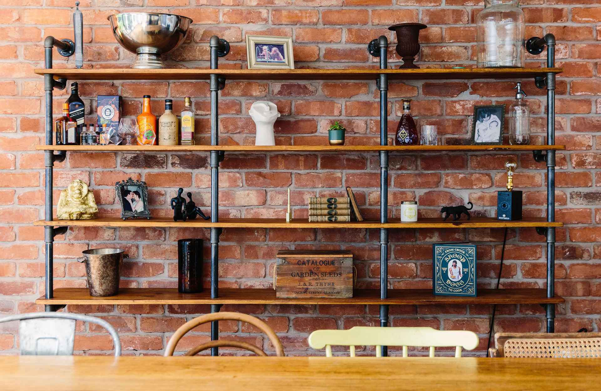 Exposed brick wall with shelves and knick knacks