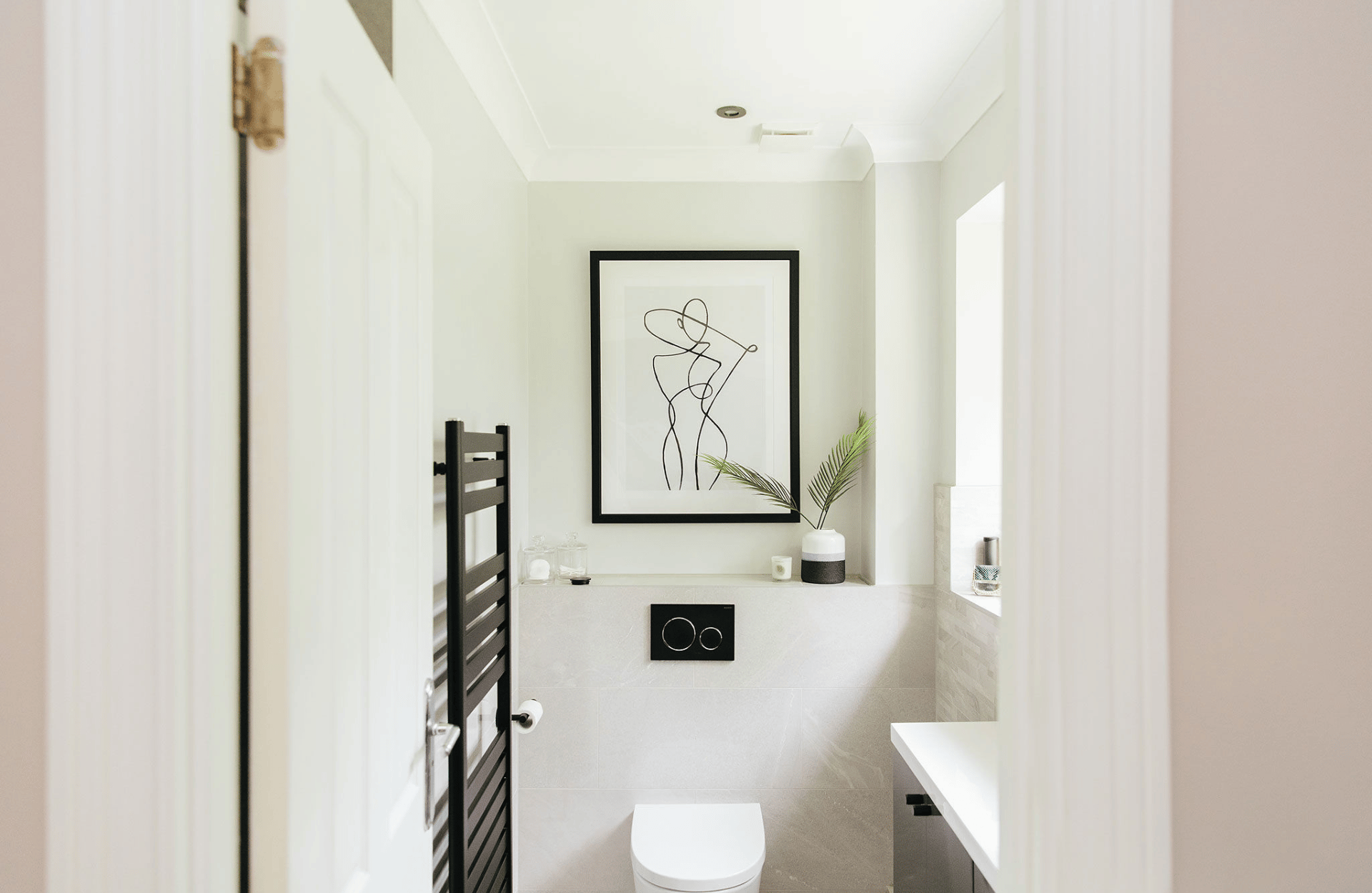 Minamlist white bathroom with black details