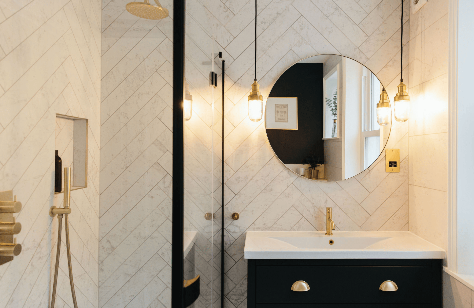 Monochrome bathroom with gold details and pendant lights
