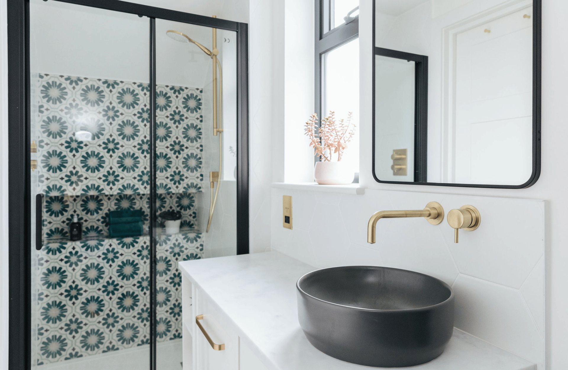 Monochrome bathroom with green and gold details