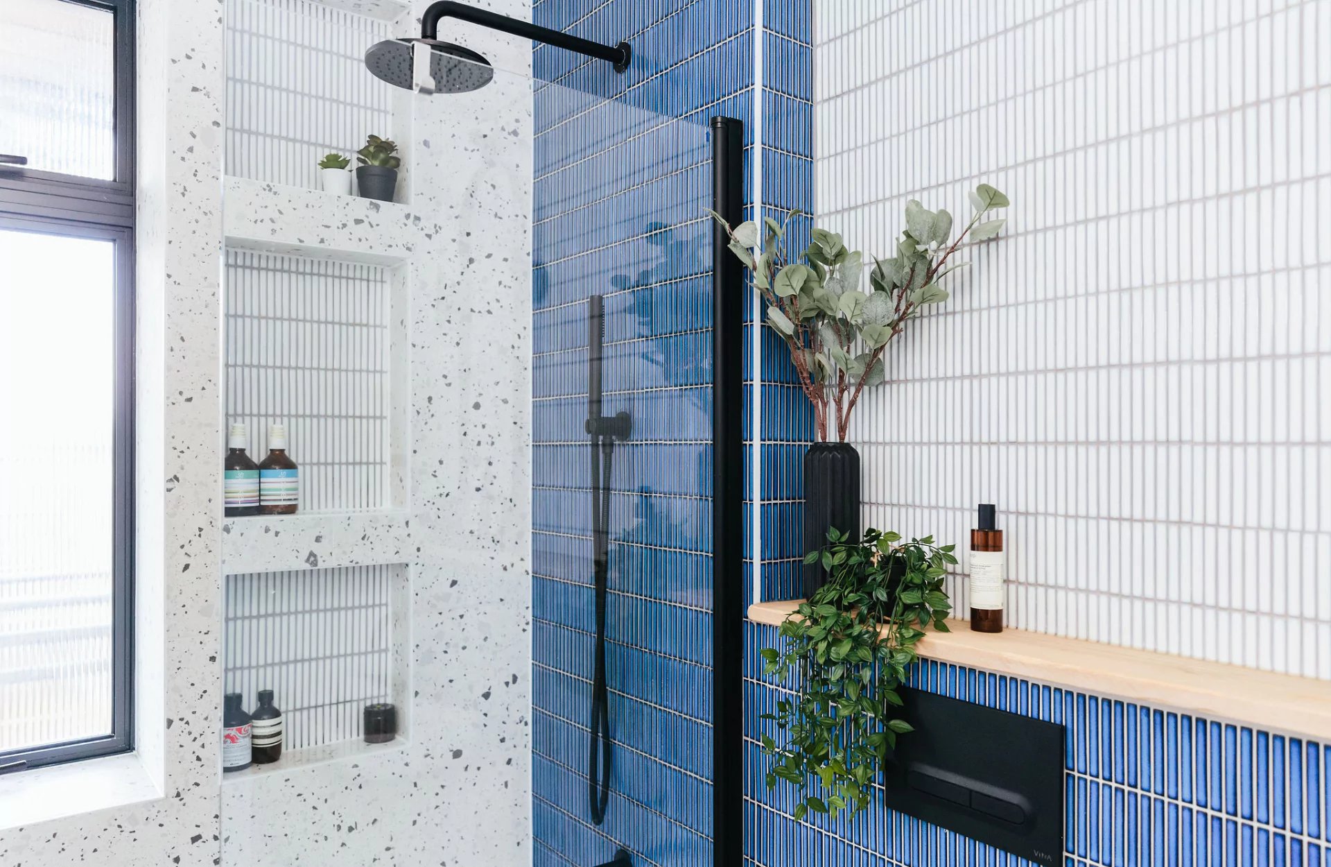 dark blue and white tiled bathroom