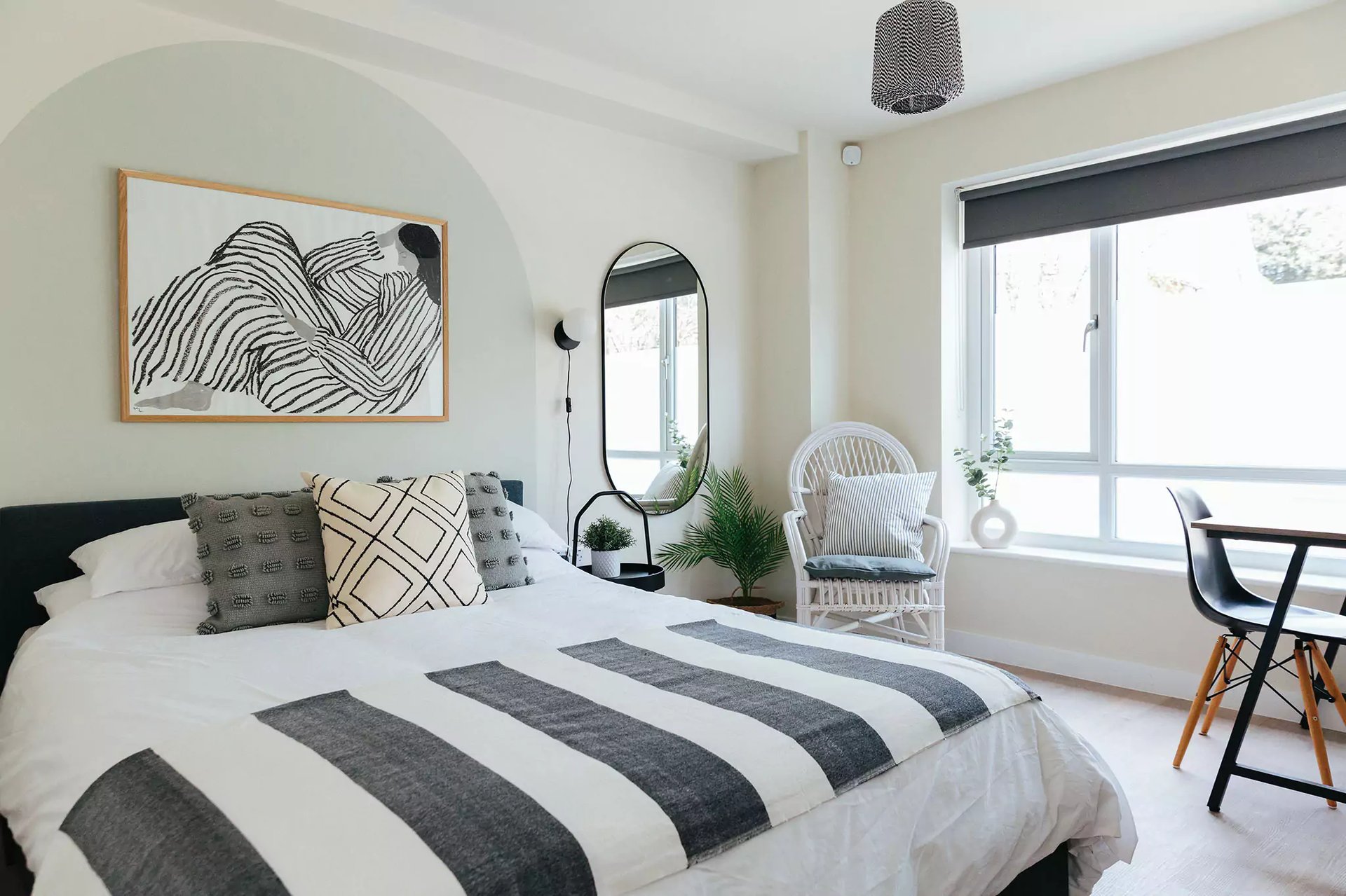 Bedroom with painted headboard and grey and white design