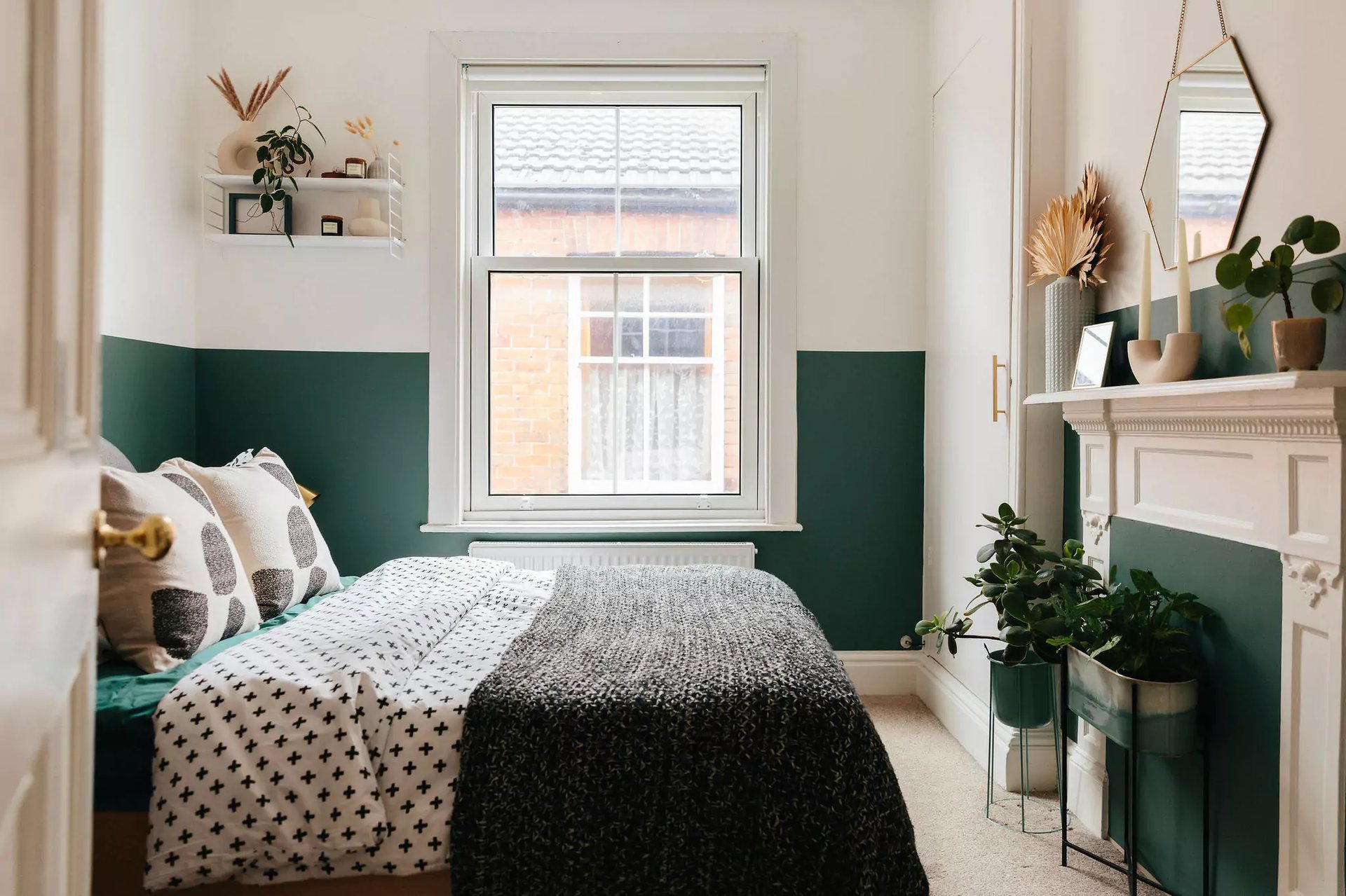 small modern bedroom with half painted green wall