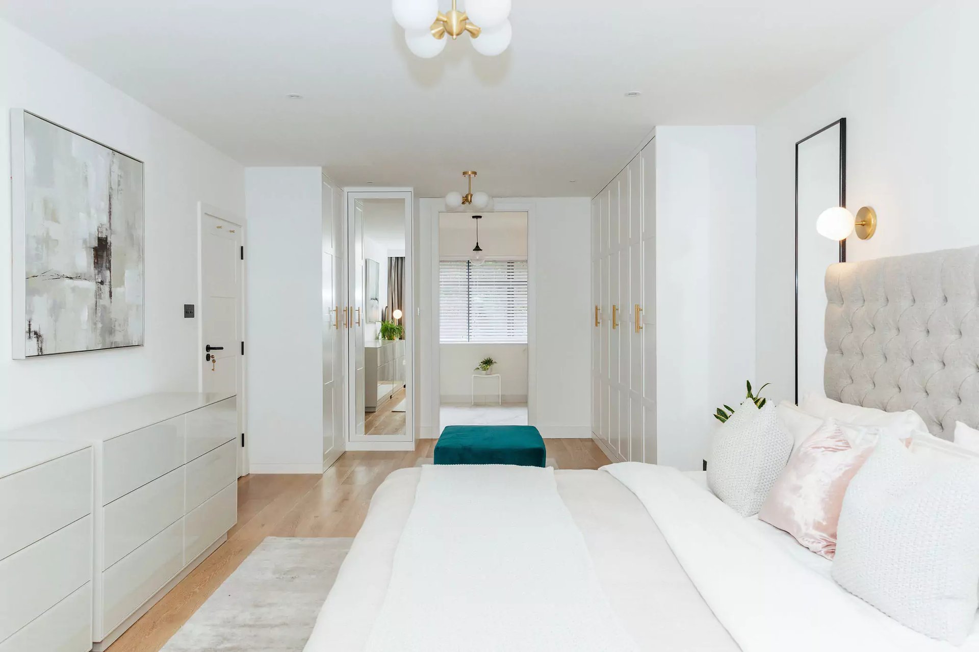 bright white bedroom with large dressing area