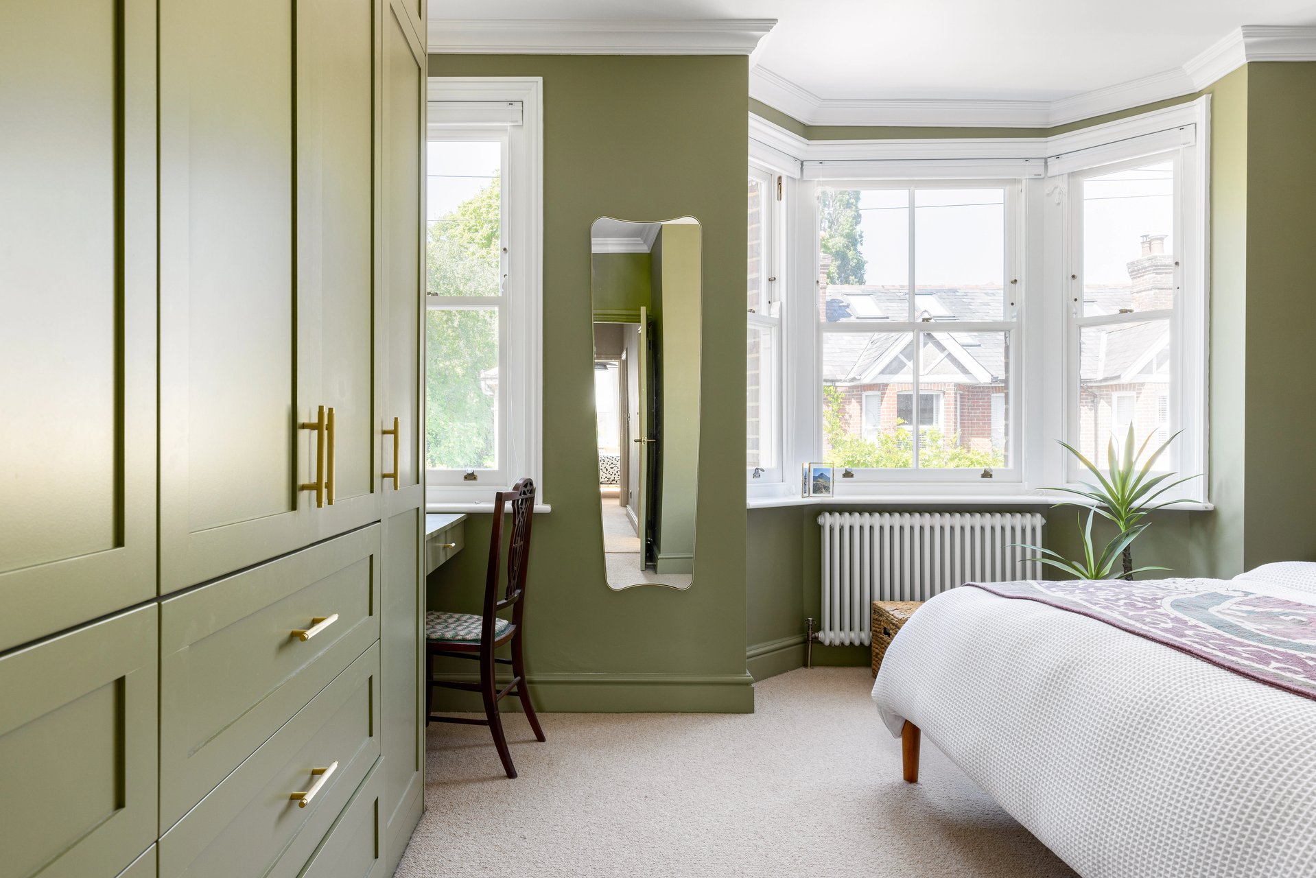 green bedroom with bespoke wardrobes