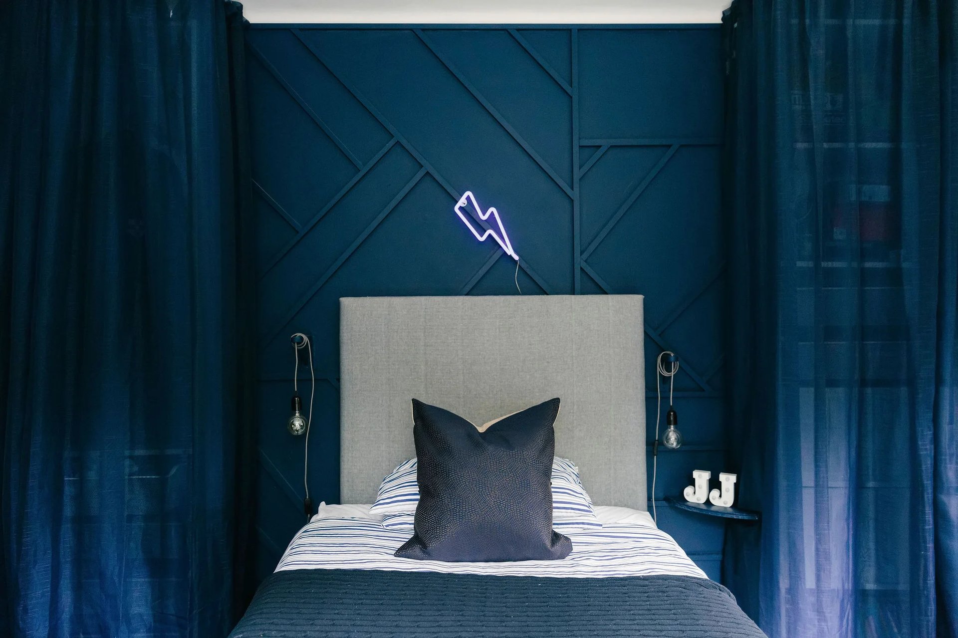 Dark blue painted panelling in kids bedroom