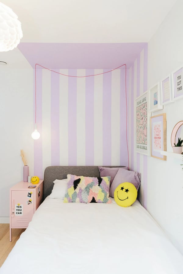 Paint in vertical stripes make this bedroom seem taller