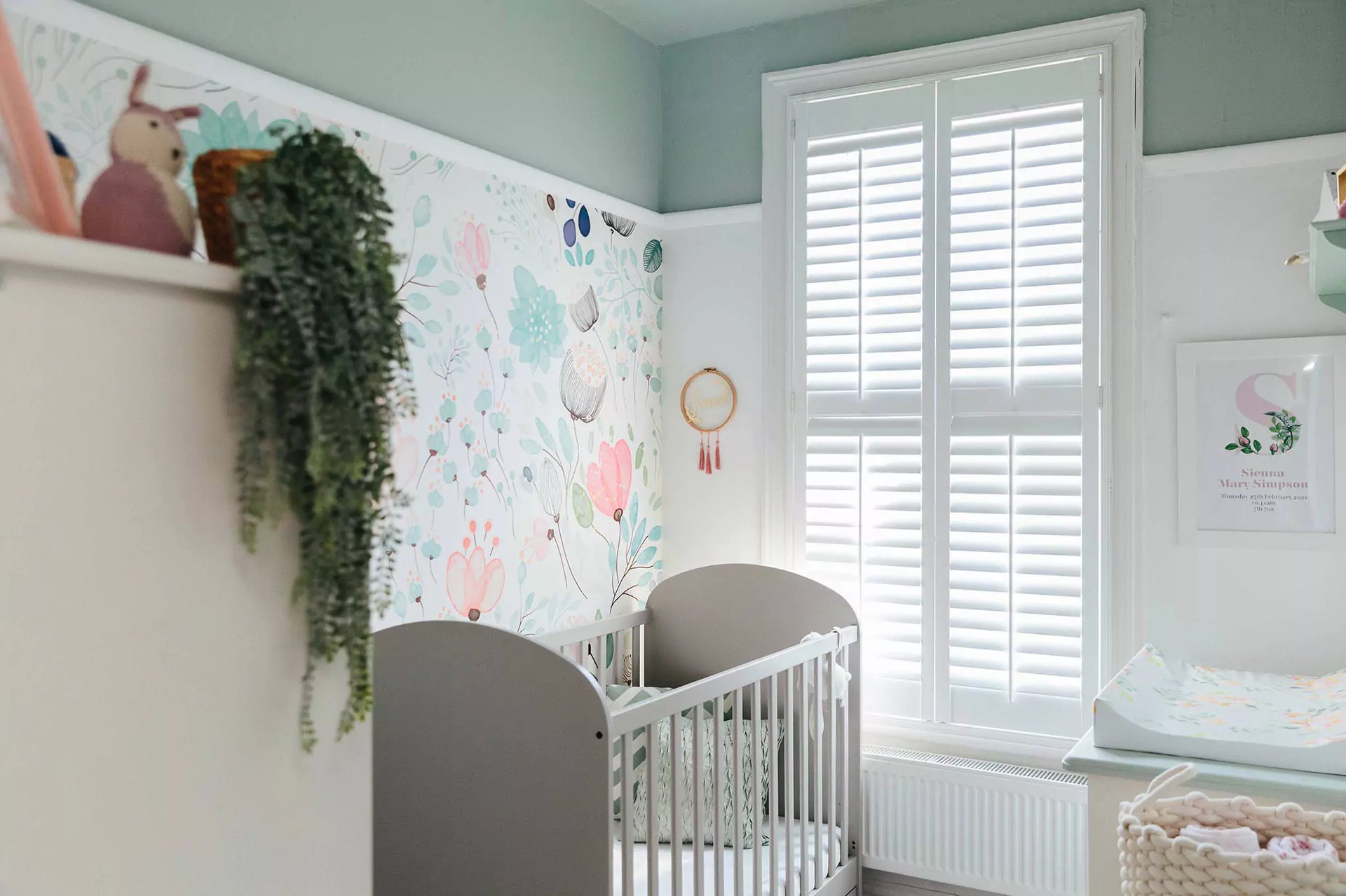 Nature insired nursery with sage green ceiling 