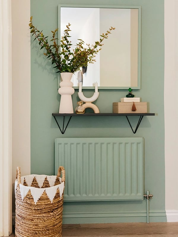 Sage green accent wall | Painted radiators in the home