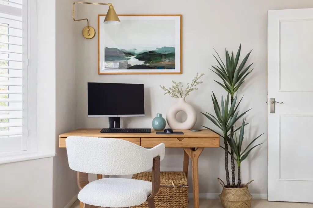 Home office with boucle chair and plants