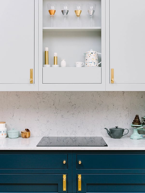 Bright white marble kitchen with blue cupboards