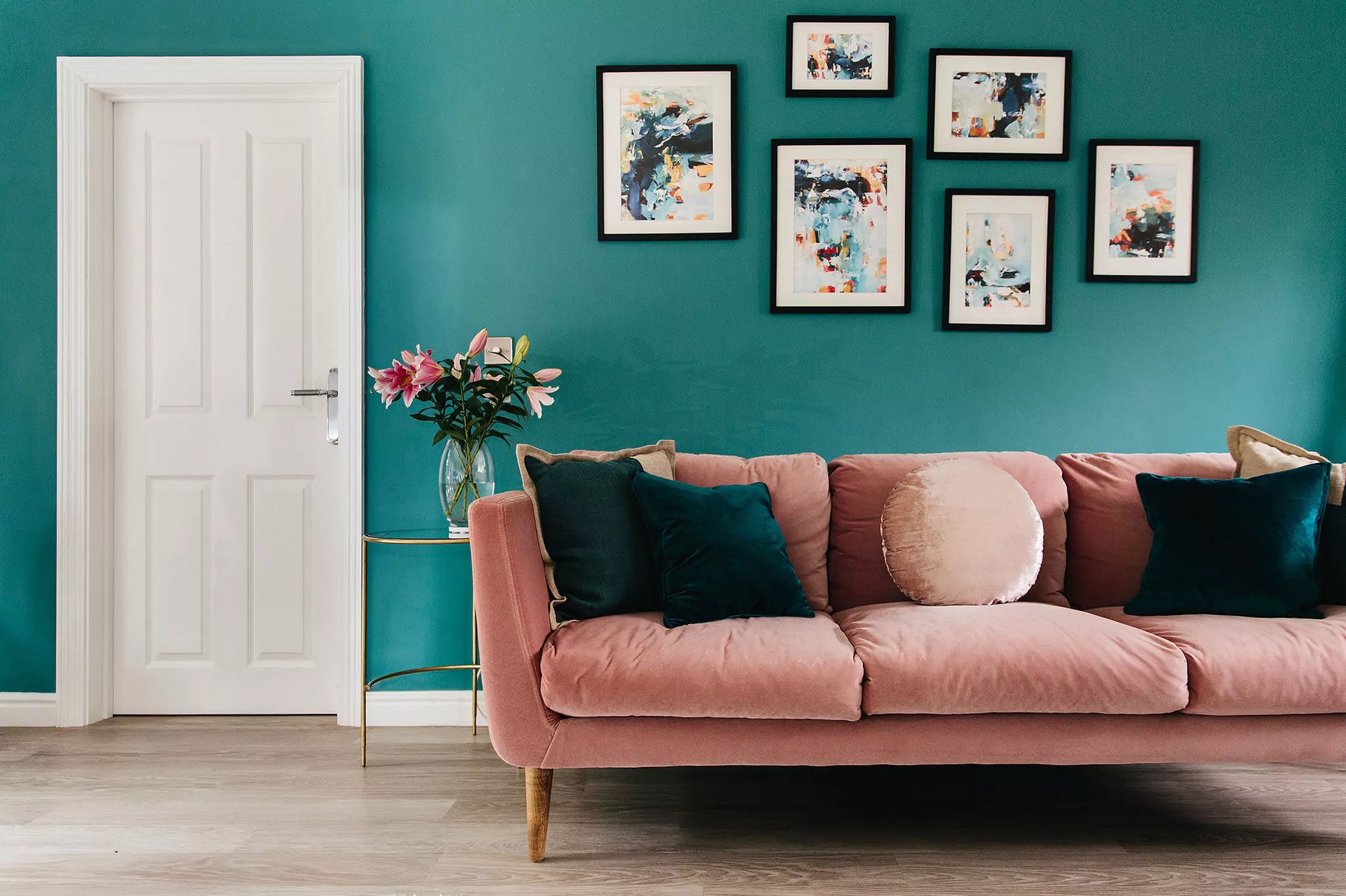 Bold living room with pink sofa and layered cushions