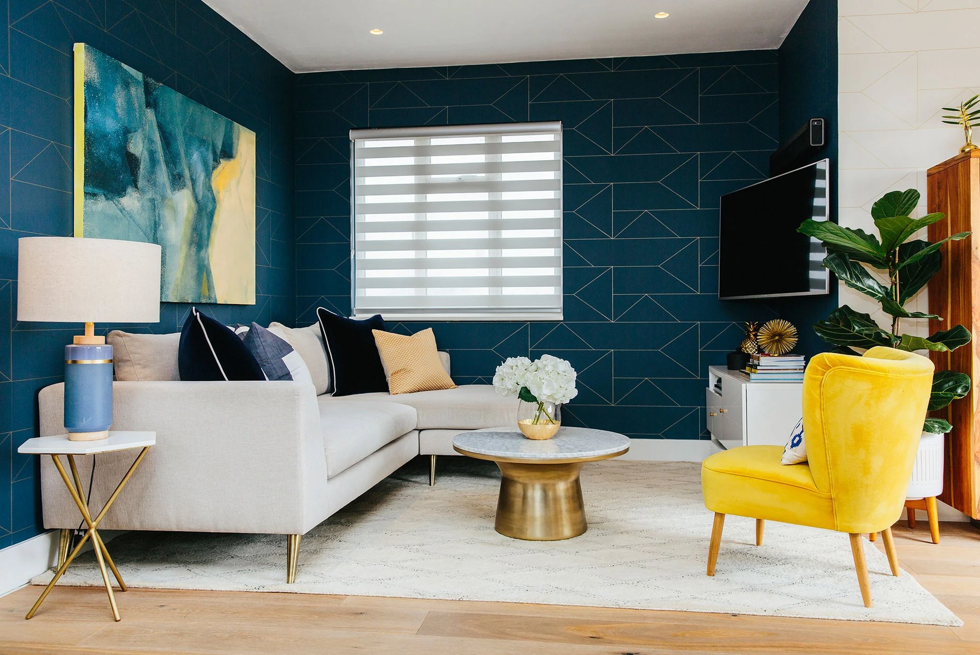 Blue living room with geometric wallpaper