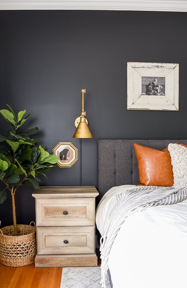 dark statement wall in bedroom with brass accents and traditional elements 