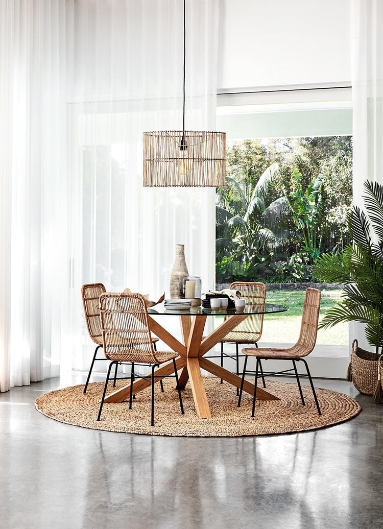 round-jute-rug-under-glass-dining-table-from-freedom-with-coastal-dining-chairs