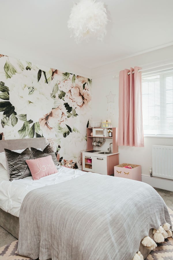 Pink and grey kids bedroom with wallpaper feature wall